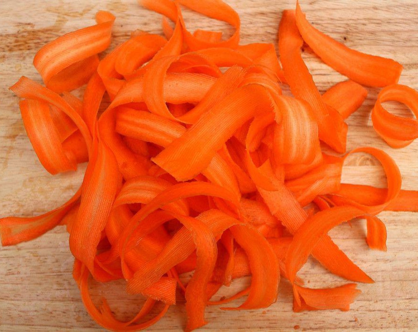 step 3 Wash and peel Carrots (4 1/2 cups). Cut with a potato peeler or a mandoline into thin, long “noodles”.