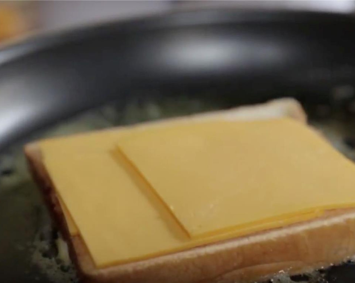 step 3 When it melts, place 1 slice of bread, mayonnaise side down, in skillet. Top with American Cheese Slices (4) and season with Ground Black Pepper (to taste).