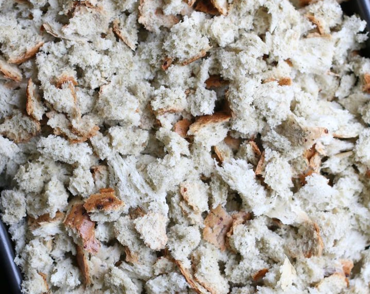 step 2 Spread Whole Grain Bread (10 cups) out on two large baking pans and bake for 20 minutes until golden brown, turning occasionally so that entire mixture is dry.  Remove from oven, put in a large bowl, cover with foil and set aside until the next day.