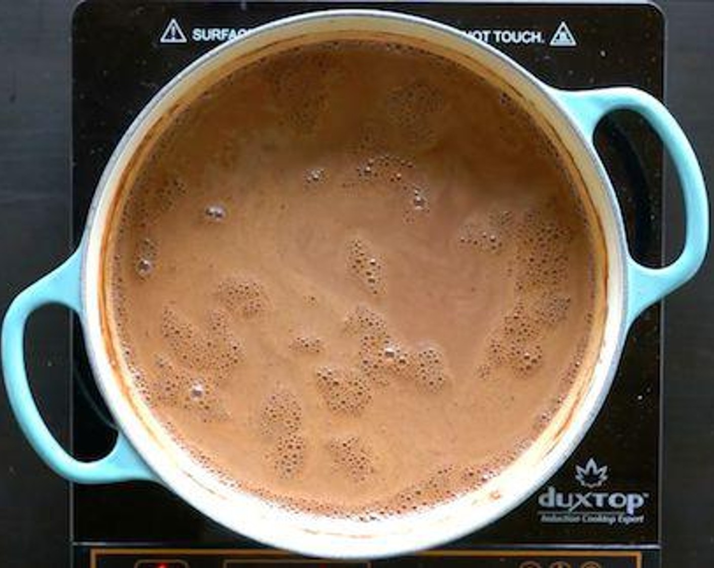 step 1 Whisk Whole Milk (3 cups), Pure Cane Sugar (3/4 cup) and Unsweetened Cocoa Powder (2/3 cup) in a ceramic or anodized stainless steel saucepan over medium-high heat. Bring to simmer. Remove from heat.