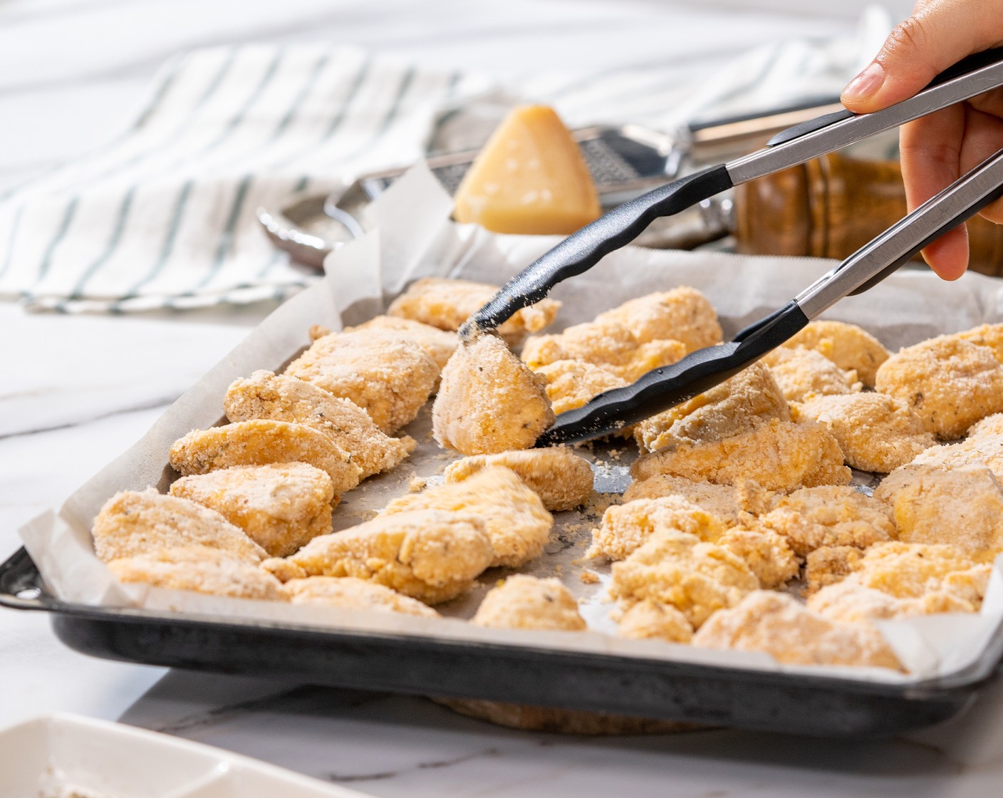 step 7 Place the chicken nuggets on the baking sheet, and slightly spray the top of the nuggets with Nonstick Cooking Spray (to taste). Bake for 10 minutes.