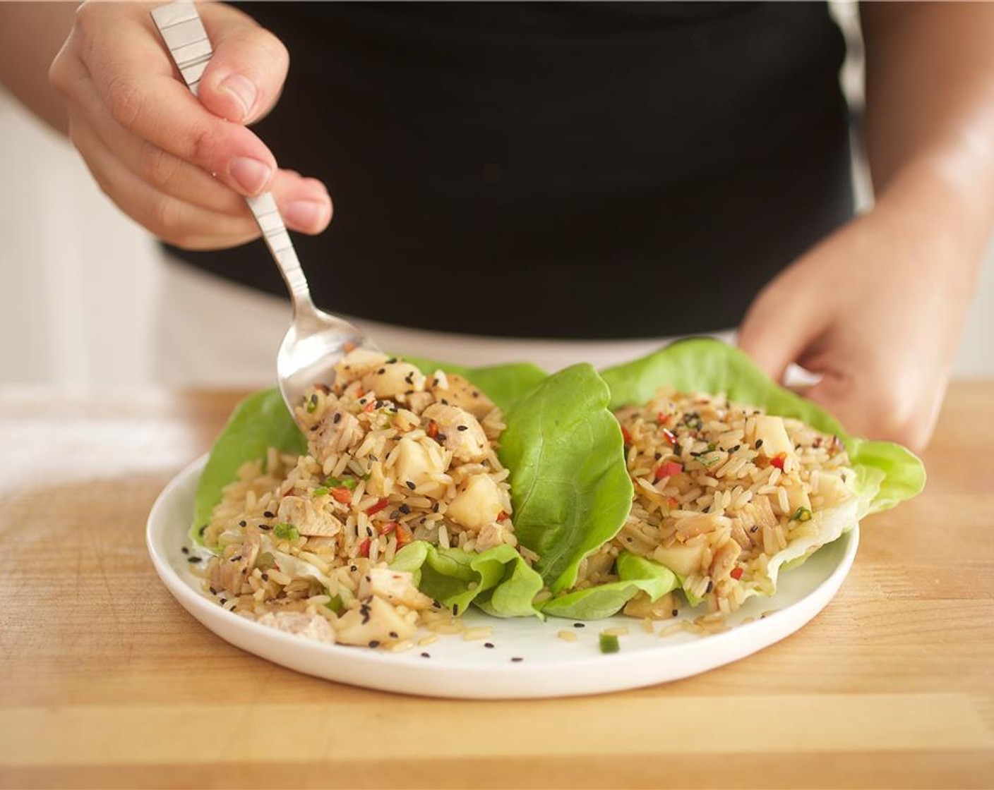 step 14 Place two Butter Lettuce (4 pieces) leaves on each plate and divide chicken and rice mixture equally among them.