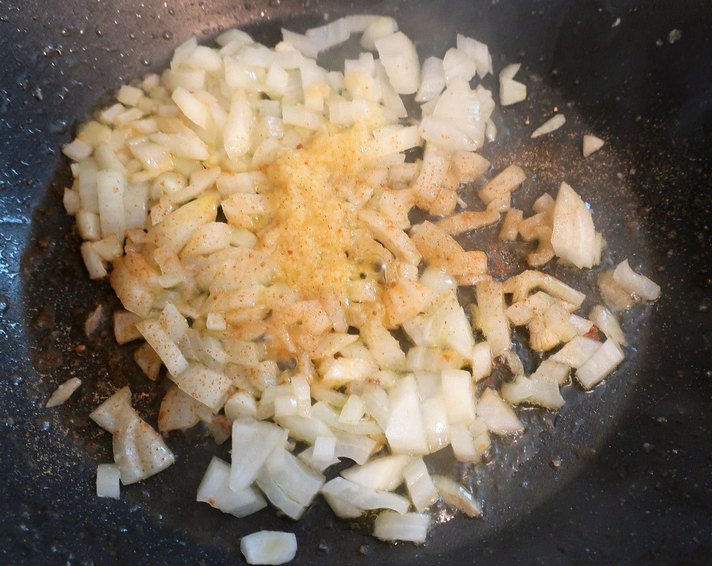 step 6 Stir fry Onion (1), Fresh Ginger (1/2 tsp) and Garlic Paste (1 Tbsp) in Peanut Oil (2 Tbsp) until translucent.