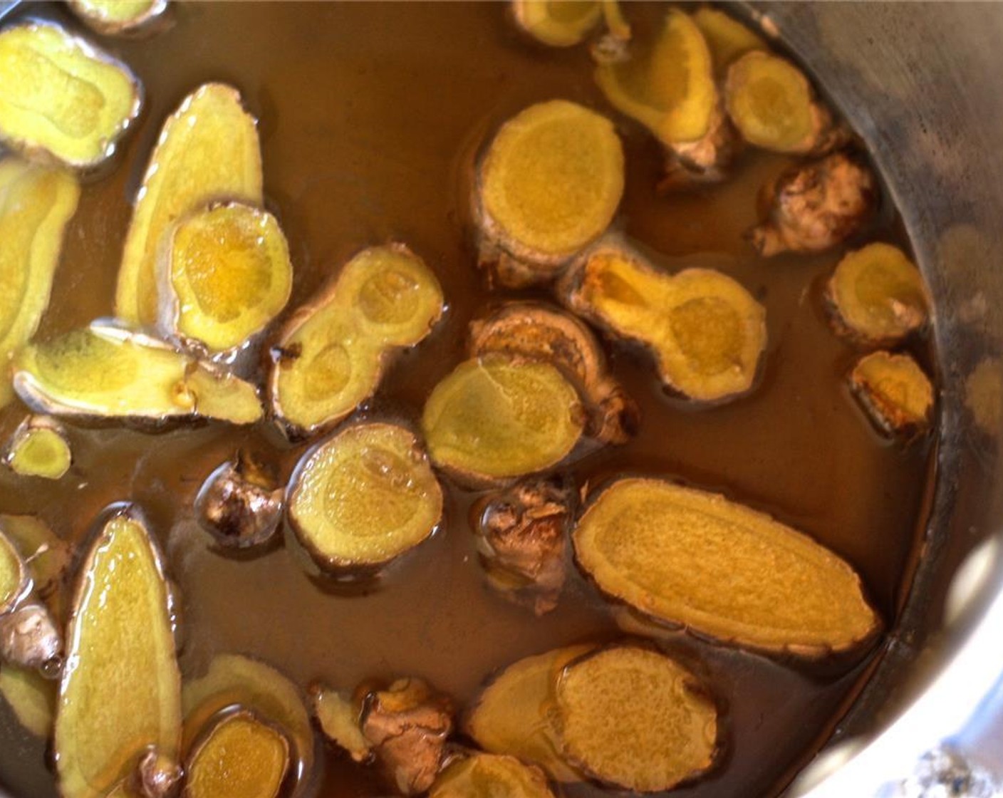 step 6 Combine the Pure Cane Sugar (1/2 cup), sliced ginger root and Water (1/2 cup) in a sauce pot.