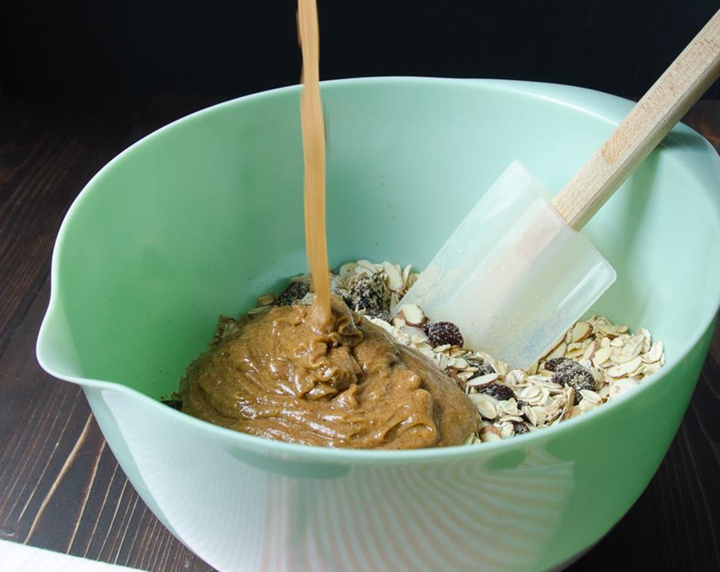 step 4 Pour the almond butter mixture over the oat mixture and using a rubber spatula mix together until evenly combined.