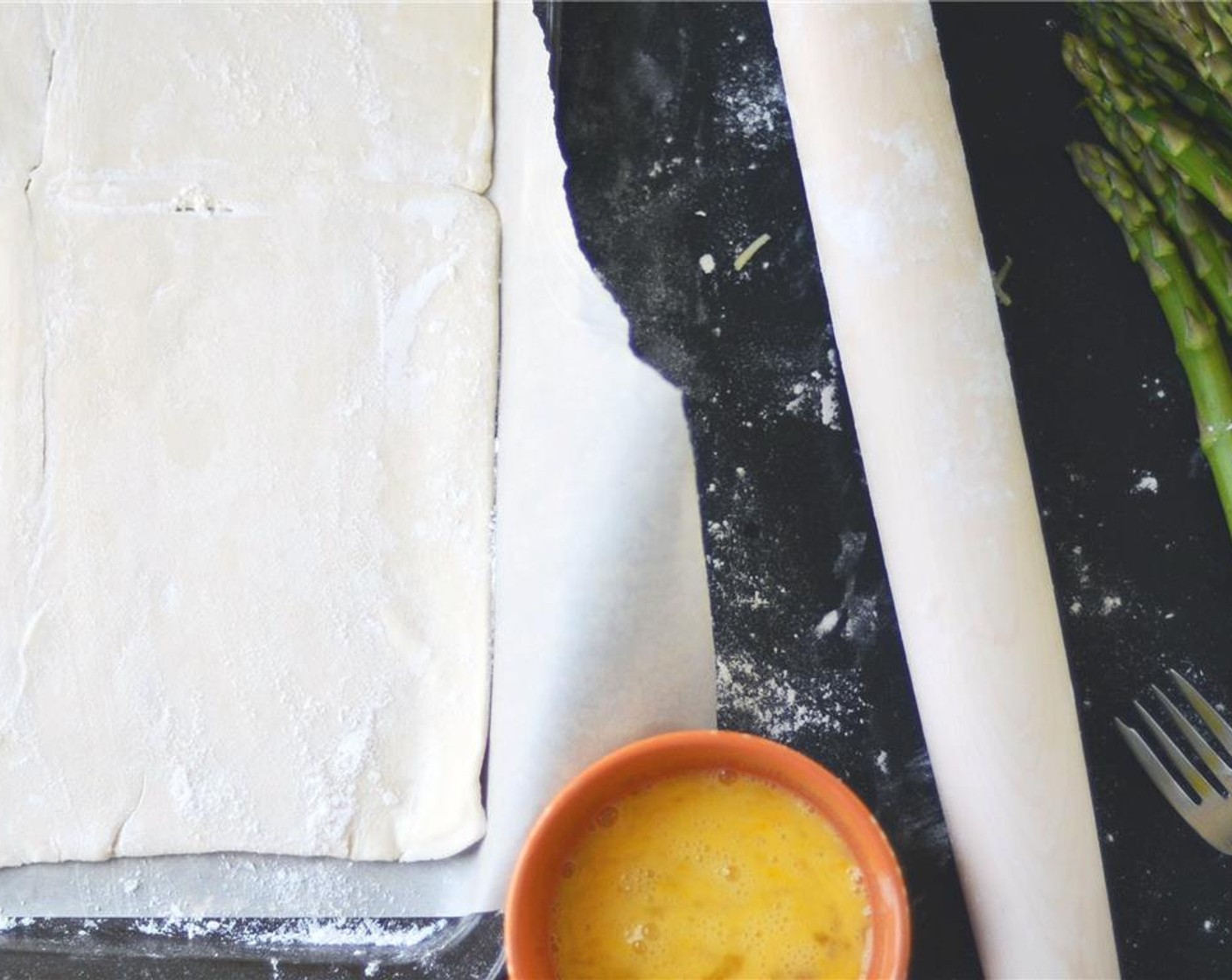 step 4 Lightly dust a clean surface with All-Purpose Flour (to taste). Unfold the Puff Pastry (1) onto a lightly floured surface. Gently roll out the dough until it is just a tad smaller than your baking sheet (about 16x10 if you are measuring).