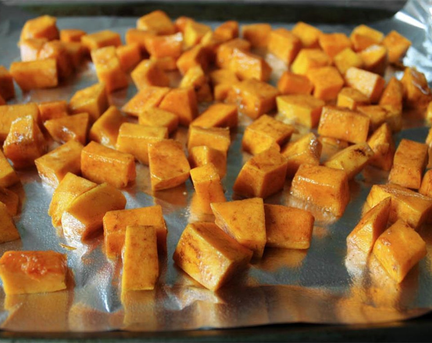 step 8 Arrange the butternut squash in a single layer on the prepared baking sheet. 20 minutes before your pork is done, transfer the butternut squash to the oven and bake for 30 minutes, turning halfway through, until the cubes are very tender.