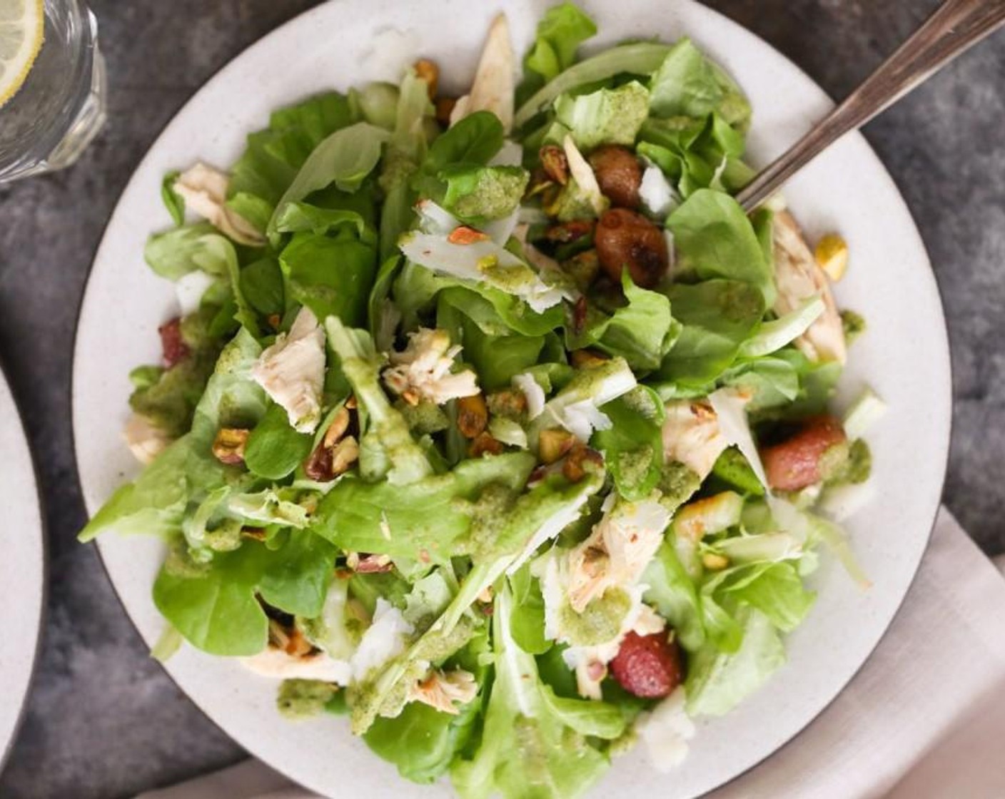 step 4 Place the Boston Lettuce (4 cups) in a mixing bowl. Add the Roasted Chicken (1 cup), roasted grapes, and Celery (1 stalk), and toss gently to combine. Dive the mixture between to large plates or bowls. Top each salad with Manchego Cheese (4 Tbsp) and Pistachios (3 Tbsp). Drizzle each salad generously with the desired amount of dressing.