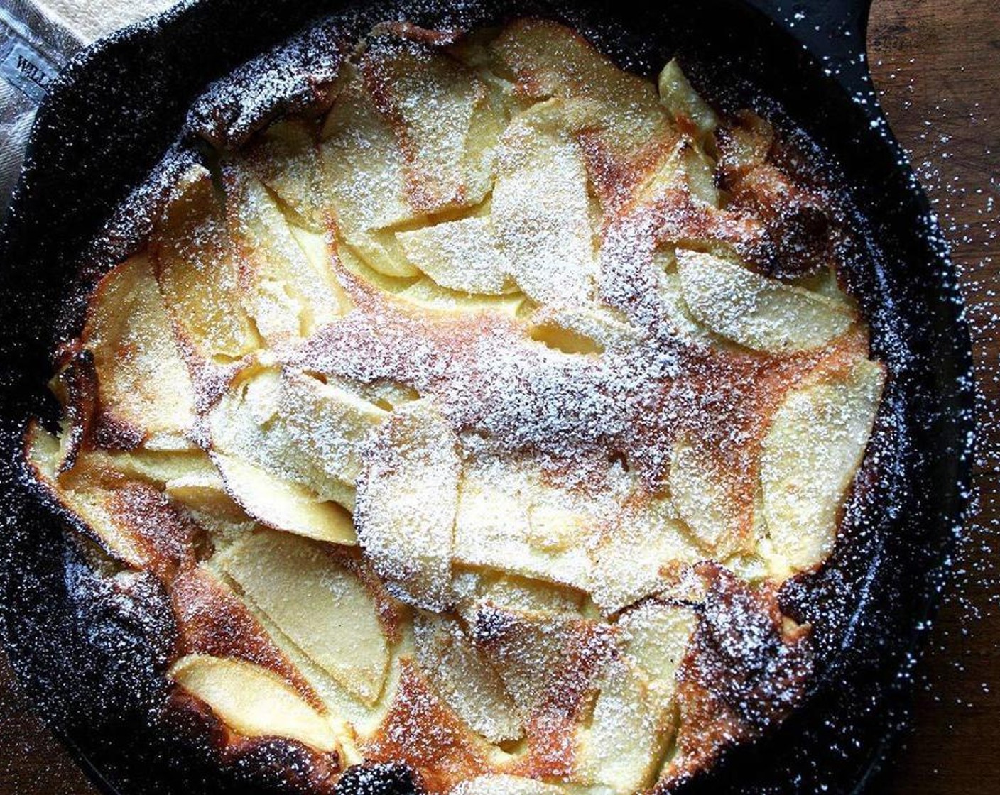 step 4 Pour batter over apple and transfer skillet to oven. Bake until pancake is puffed and golden, about 15 minutes. Dust with Powdered Confectioners Sugar (to taste) and serve immediately.