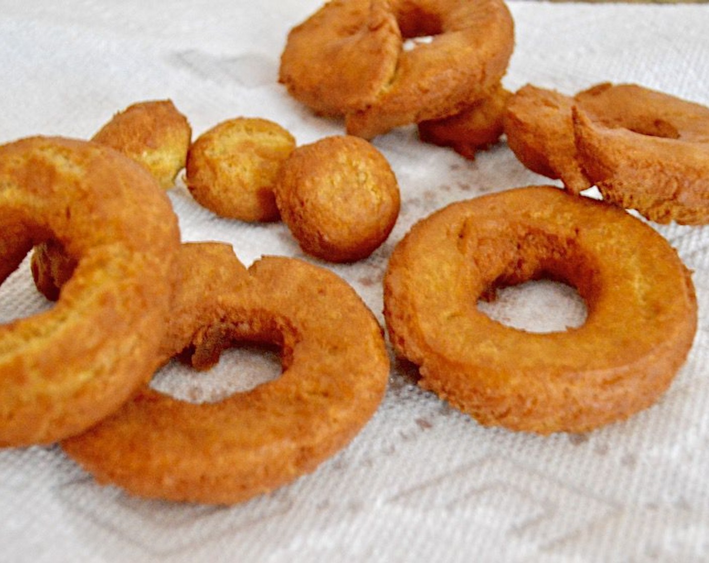 step 9 Fry the donuts in batches for about a minute on each side, removing them to a plate lined with paper towel to drain. While they cook, stir the remaining pumpkin pie spice and granulated sugar together.