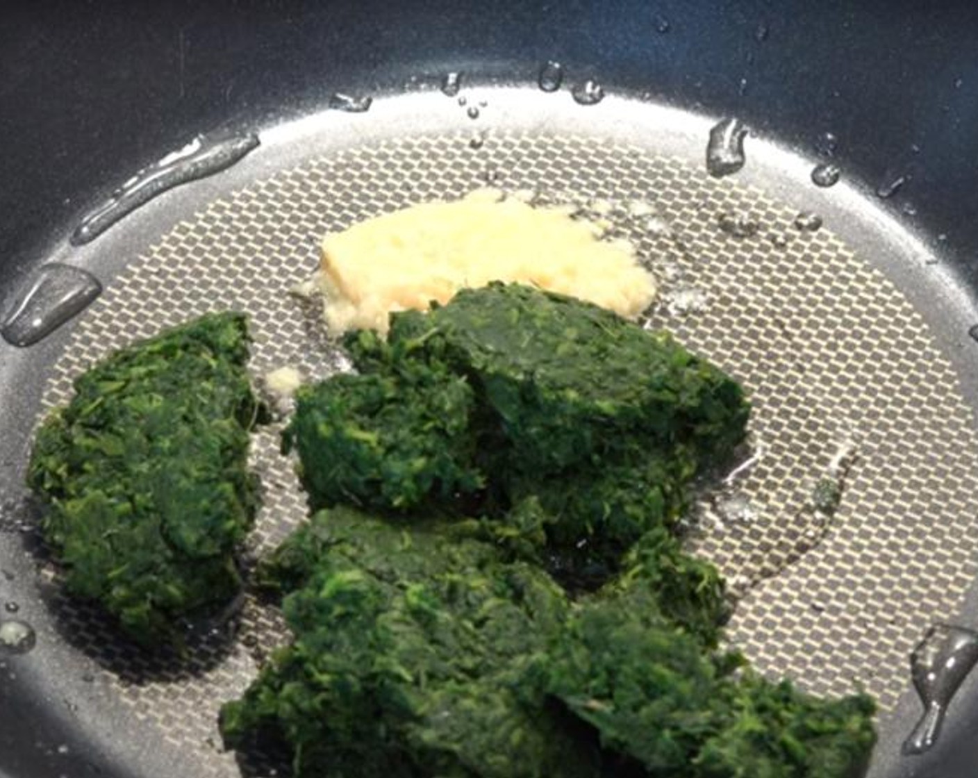 step 1 Pour Olive Oil (as needed) into a frying pan over medium heat. Add Garlic (1 clove) and Frozen Spinach (1 2/3 cups). Stir around for about 2-3 minutes, or until any excess liquid has evaporated.