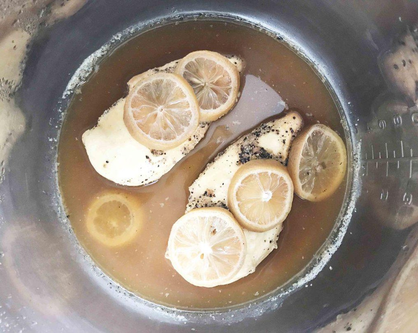 step 1 Place the Boneless Skinless Chicken (1 lb), Hard Lemonade (1 cup), sliced and deseeded Lemon (1), Salt-Free Lemon Pepper (1 Tbsp), and Sea Salt (1/2 tsp) into the base of a pressure cooker or crockpot.