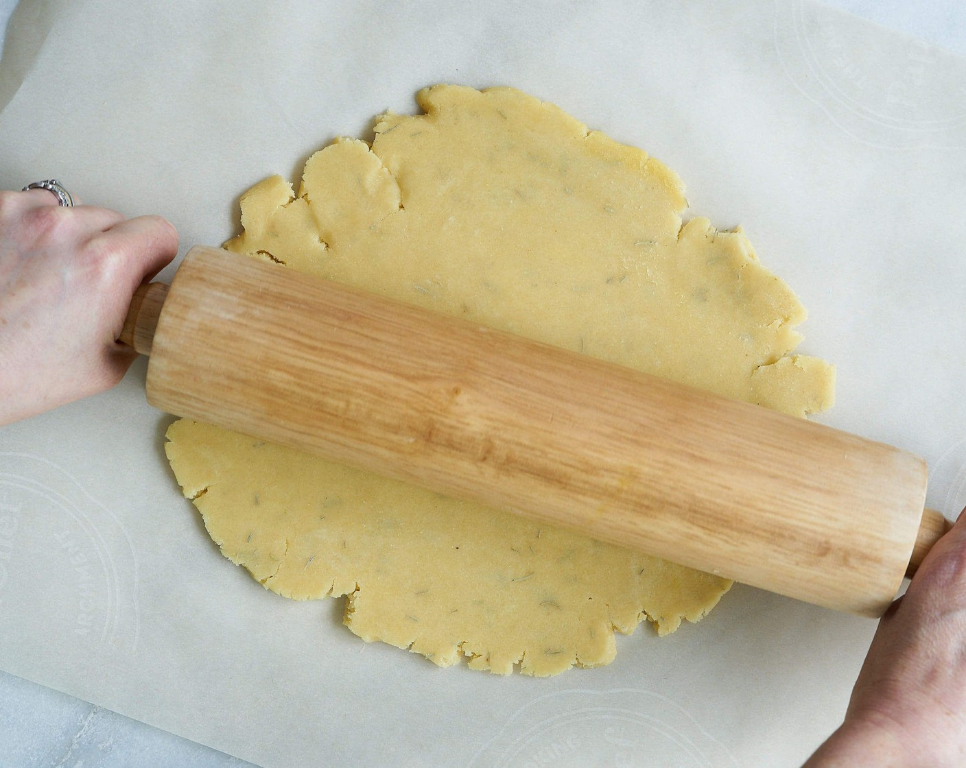 step 6 Remove the dough from the fridge and sprinkle flour on to rolling pin so it doesn't stick. Roll out dough on to parchment paper to about 10 inches in diameter. It doesn't have to be perfect, it's a rustic!