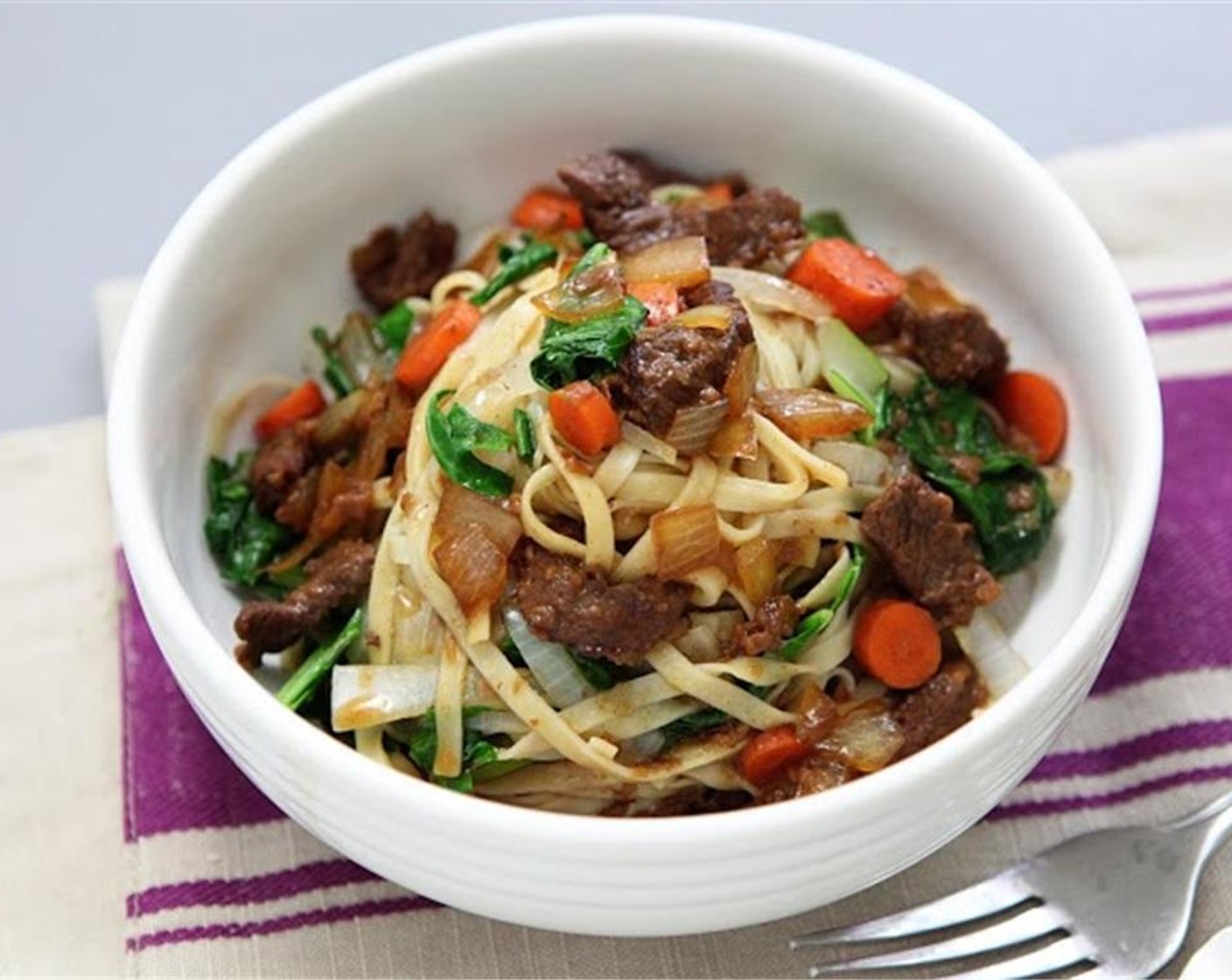 step 8 Cook the pasta for 4 minutes in the boiling pot of water. Drain, and rinse with running water, then add to the pan with choy sum and onion. Stir to combine. Serve the beef and sauce over the noodle mixture and enjoy!