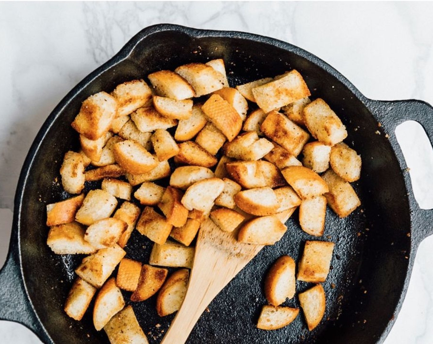 step 2 Add the bread to a large saute pan or cast iron skillet and drizzle with Olive Oil (2 Tbsp). Toss until most of the bread is coated in oil. Sprinkle with Salt (1/8 tsp), Ground Black Pepper (to taste), McCormick® Garlic Powder (to taste), and Italian Seasoning (to taste).