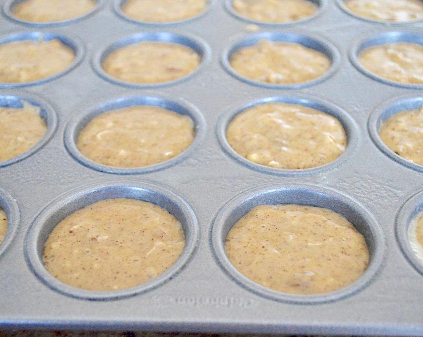 step 5 Into each well of a 24-well mini muffin tin sprayed very generously with Coconut Oil Cooking Spray (as needed) scoop enough batter to pretty much fill them to the top. Bake them for 15-20 minutes, until they are golden and a toothpick inserted into the center comes out clean.