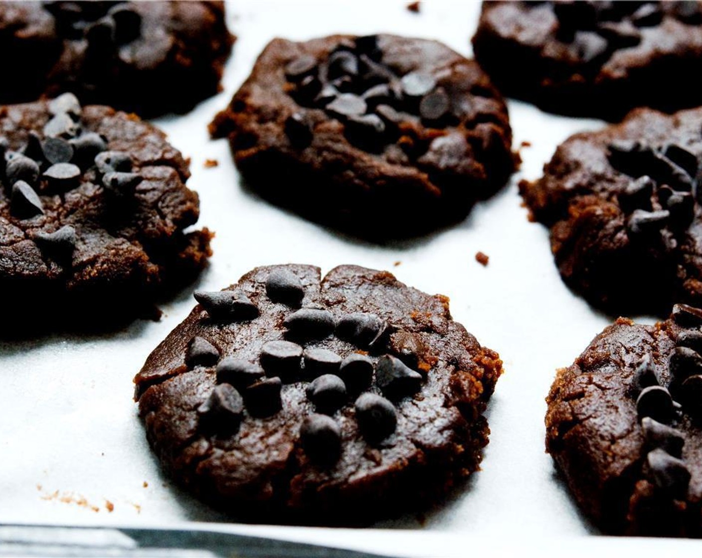 step 5 Flatten out each ball with a glass and place a few Mini Chocolate Chips (1/2 cup) onto each cookie.