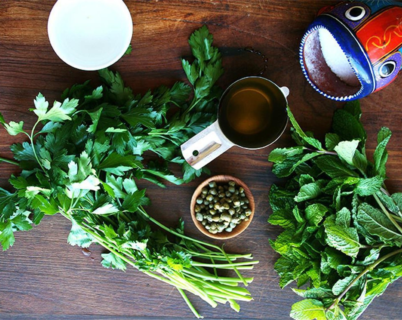 step 2 Process Fresh Mint (2 cups) and Fresh Parsley (2 cups) in a food processor until finely chopped. Scrape down the side of the processor. Drain and rinse Capers (1 1/3 Tbsp).