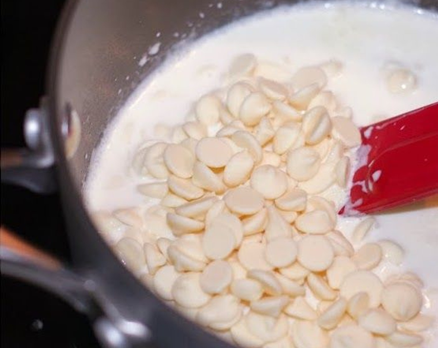 step 7 Place Heavy Cream (2/3 cup) in a small saucepan and bring to a simmer over low heat. Stir in the White Chocolate Chips (1 cup) until melted, then add the Butter (2 Tbsp). Stir until well blended.
