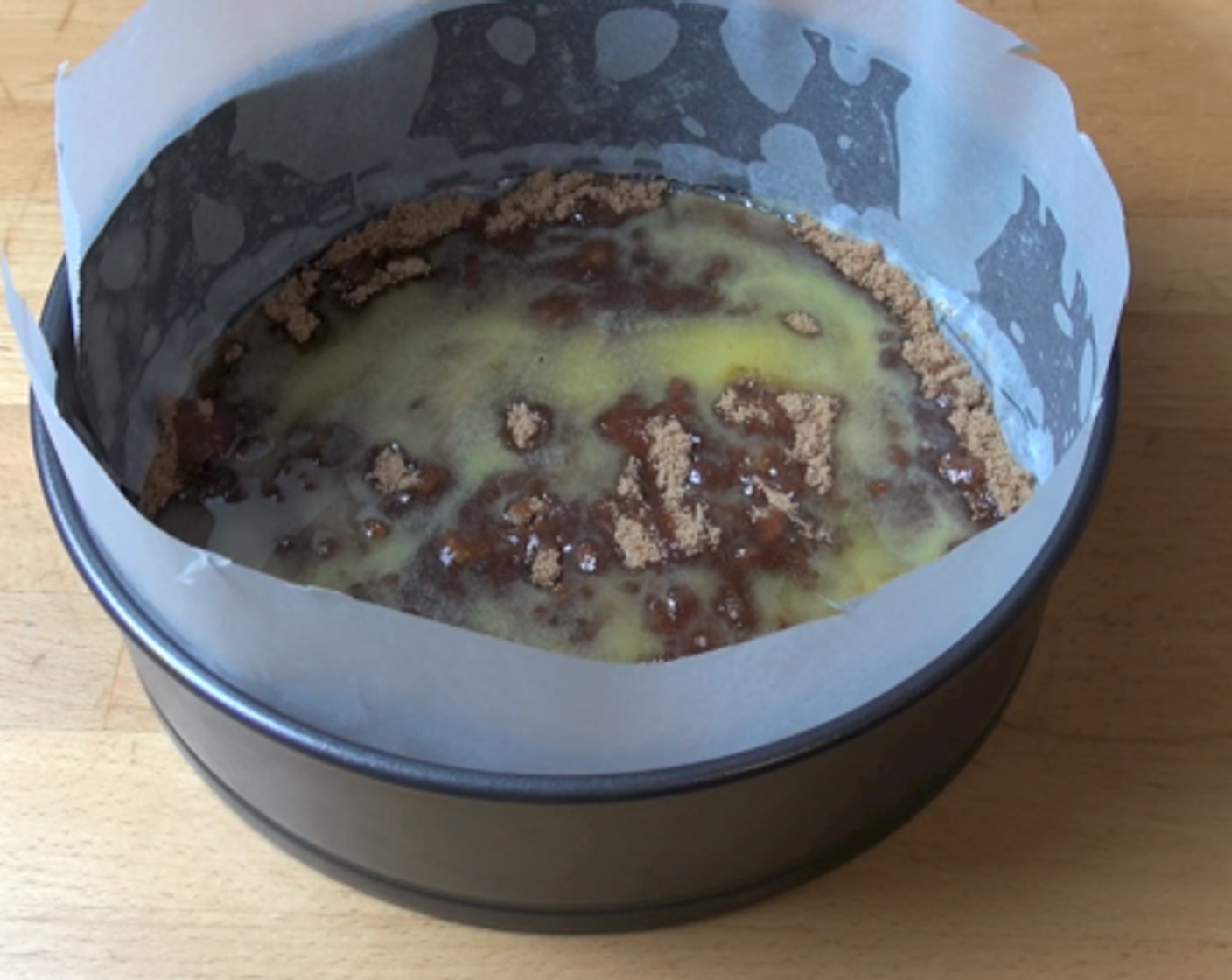 step 2 Start by lining a 22 centimeter cake pan with baking paper on the base and sides. Over the base, sprinkle Brown Sugar (1/2 cup), then Butter (2.5 oz).