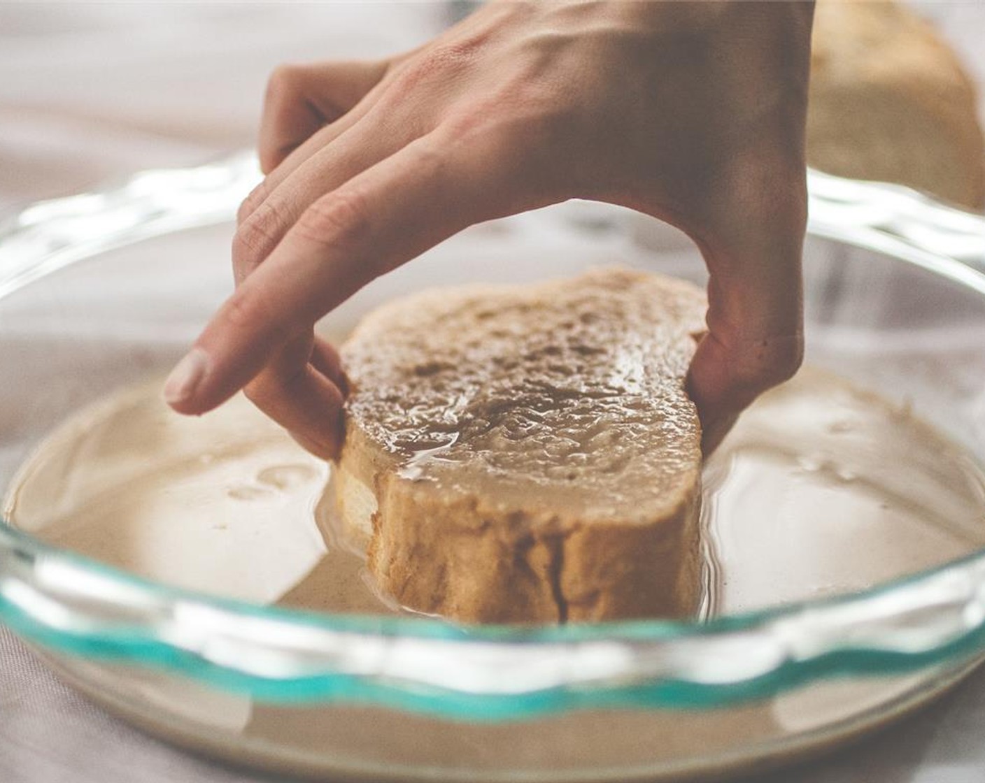 step 3 Coat a slice of bread in the french toast liquid for about 10 seconds on each side. The bread should feel slightly heavier but not soaked completely through. That's the trick!