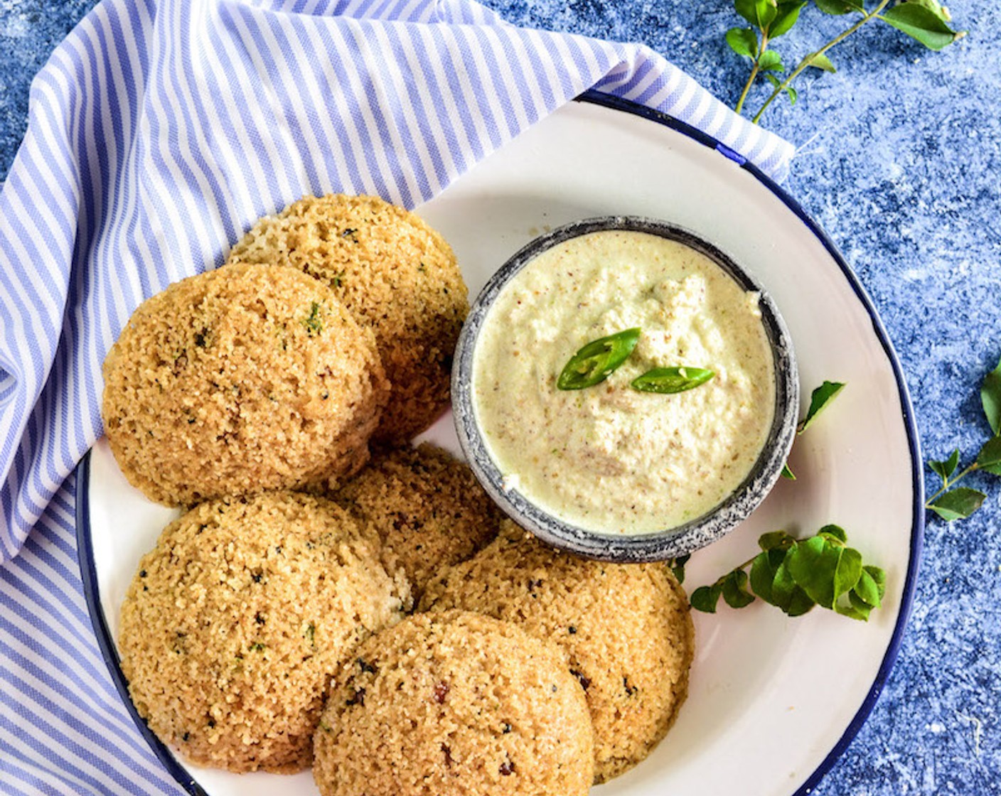 step 11 Now carefully take out the Idlis by running a knife on sides. Plate the hot and fluffy Rawa Idlis in a plate and serve hot with green chili and coconut chutney.