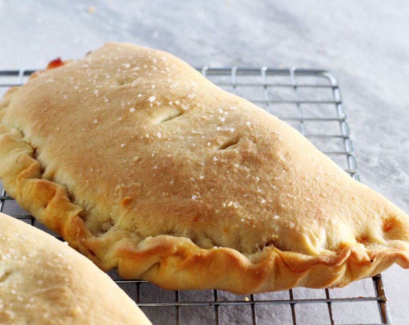 step 11 Bake on the center oven rack for 20 minutes, until the calzones are golden brown. Remove from the oven and transfer to a wire rack to cool.