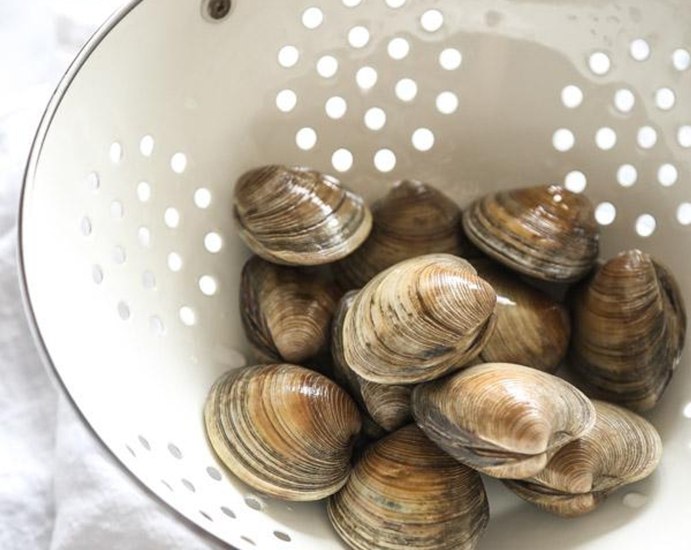 step 1 Rinse the Littleneck Clams (2 lb) well and place in a large mixing bowl. Cover with cold water and soak while prepping the remaining ingredients.