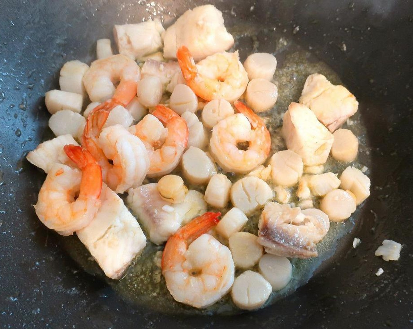 step 4 Season the Shrimp (6), Fish Fillets (12 oz) and Scallops (8 oz) with Kosher Salt (to taste) and Cayenne Pepper (to taste), stir fry until cooked halfway through, remove.