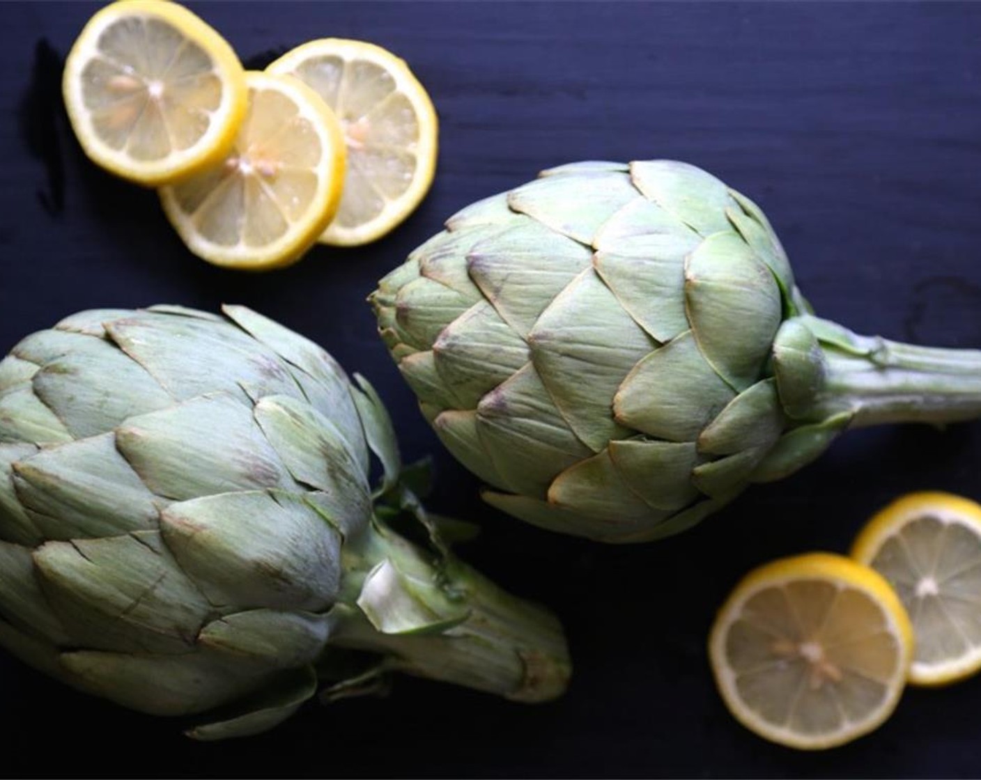 step 1 Bring a large pot of water to a boil. Add the Lemons (2) and Artichokes (2) to the pot and lower to a simmer. Cover the lid and cook for about 30 to 35 minutes.