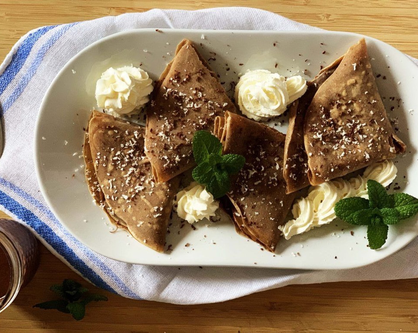 step 4 Spread your desired filling on one side of the crepes, then fold them in half and then again. I added some grated dark vegan chocolate, dry coconut and a bit of vegan whipped cream. Add a drizzle of maple syrup if you want to add a bit of extra juice and sweetness.