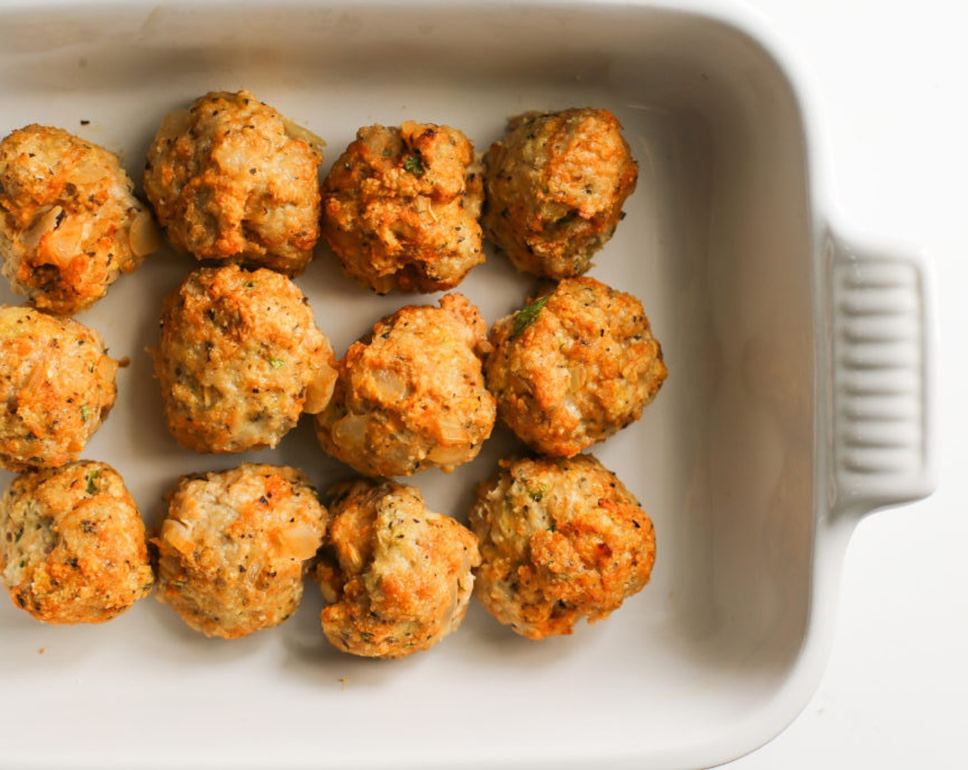 step 5 Line a baking sheet with foil (or not) and drizzle with 2-counts of olive oil. Scoop or roll 2-inch meatballs and lay snug on the sheet. Drizzle with one more count of oil on top of the meatballs and bake for 20 minutes until cooked through.