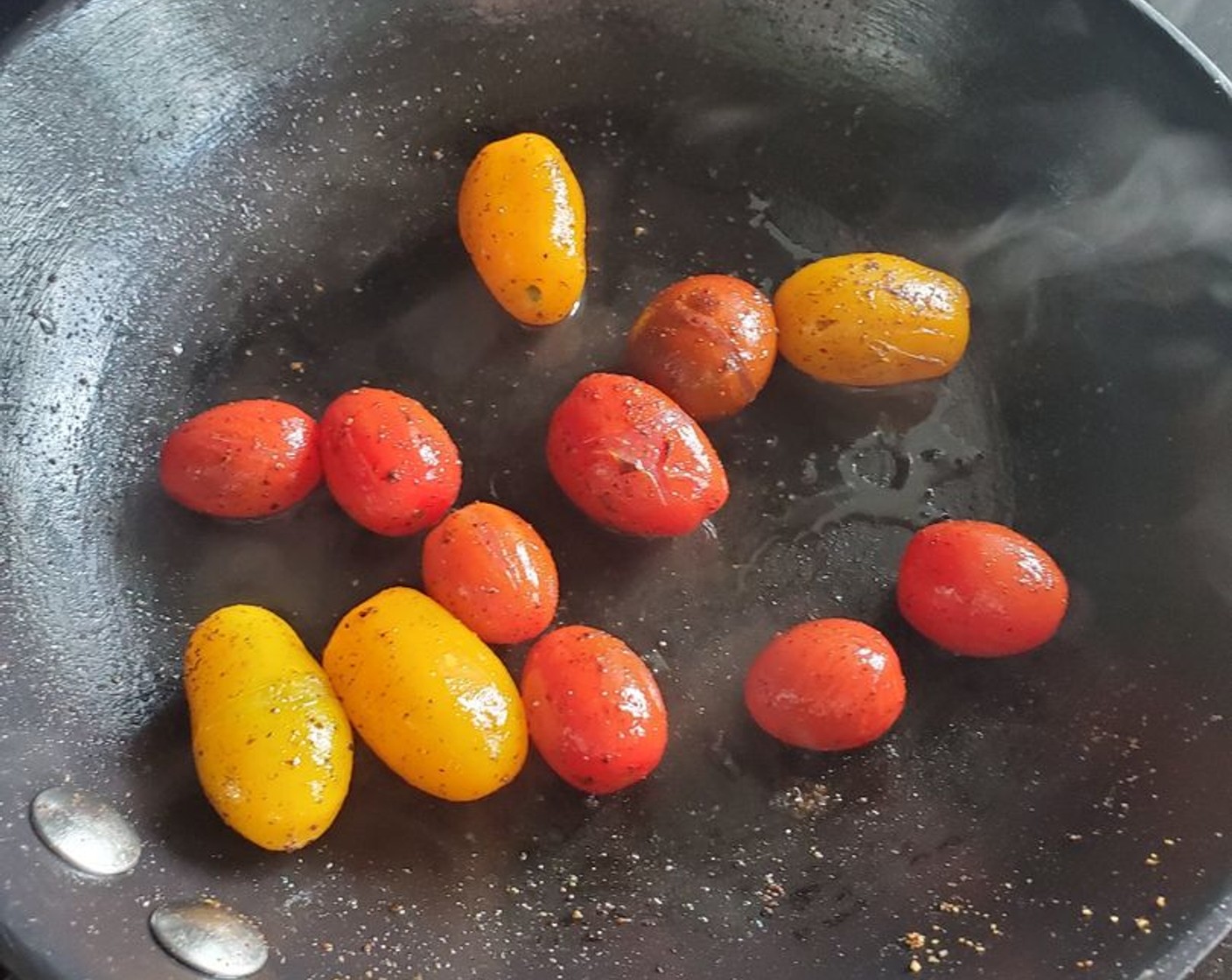 step 5 To a frying pan over medium heat, add about 1 Tbsp of regular Olive Oil (as needed). Add Grape Tomatoes (12) and sauté until they start to caramelize and pop. Remove from heat.
