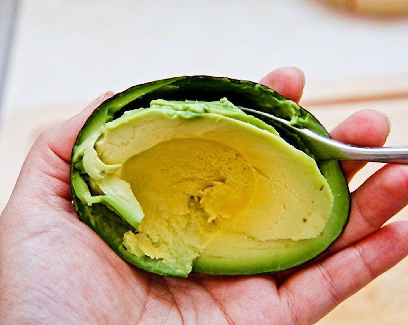 step 4 For the second combination, use avocado and turkey. Pit and scoop the Avocado (1).