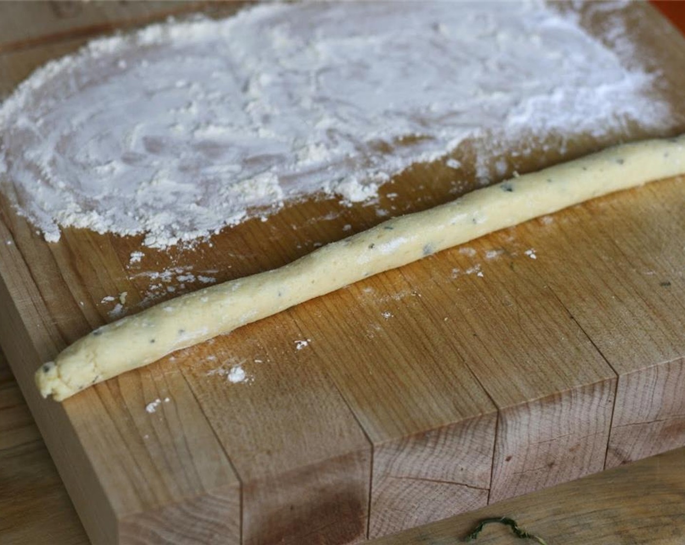 step 6 Dust your hands and work surface with a little of the remaining flour mixture. Break off a tennis-ball sized piece of the dough and roll it into a thick rope, about 3/4-inch thick.