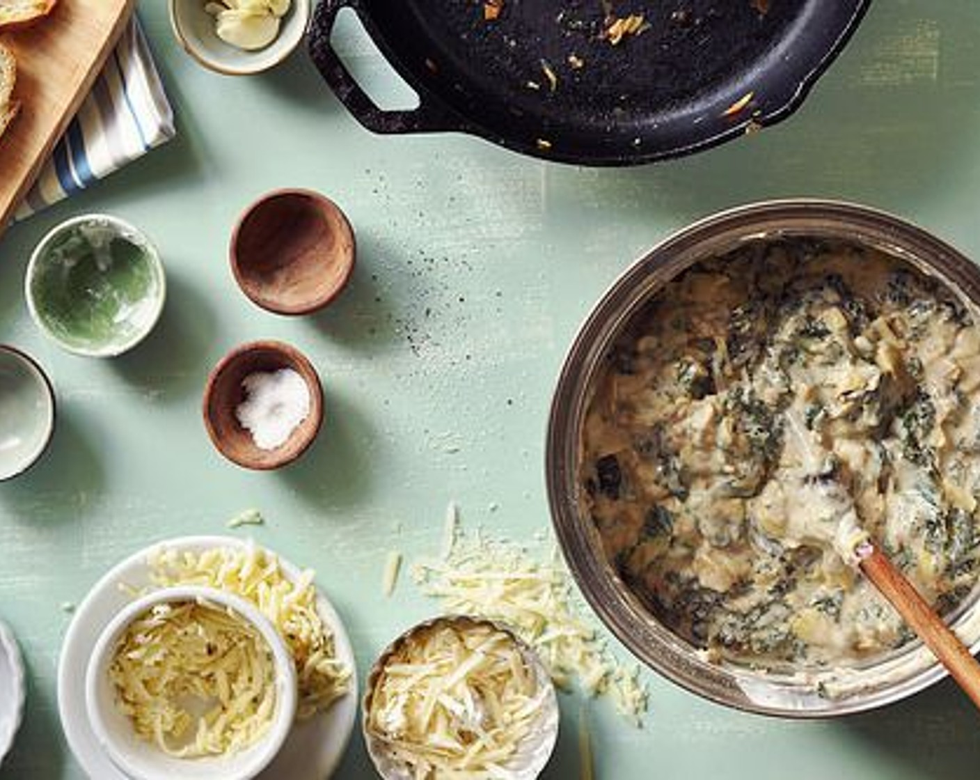 step 11 Remove from heat and stir in the Pepper Jack Cheese (1 cup) and Parmesan Cheese (1 cup), reserving a bit of each to top the dip with later. Fold in the kale and artichoke hearts.