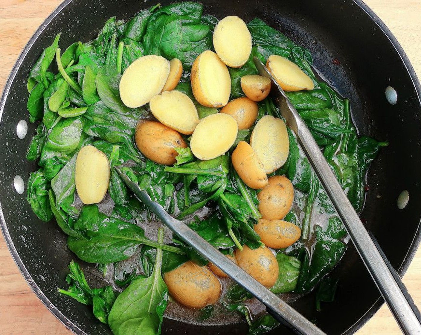 step 11 Add the potatoes and Water (1/4 cup), saute until spinach has wilted and the potatoes have heated through.