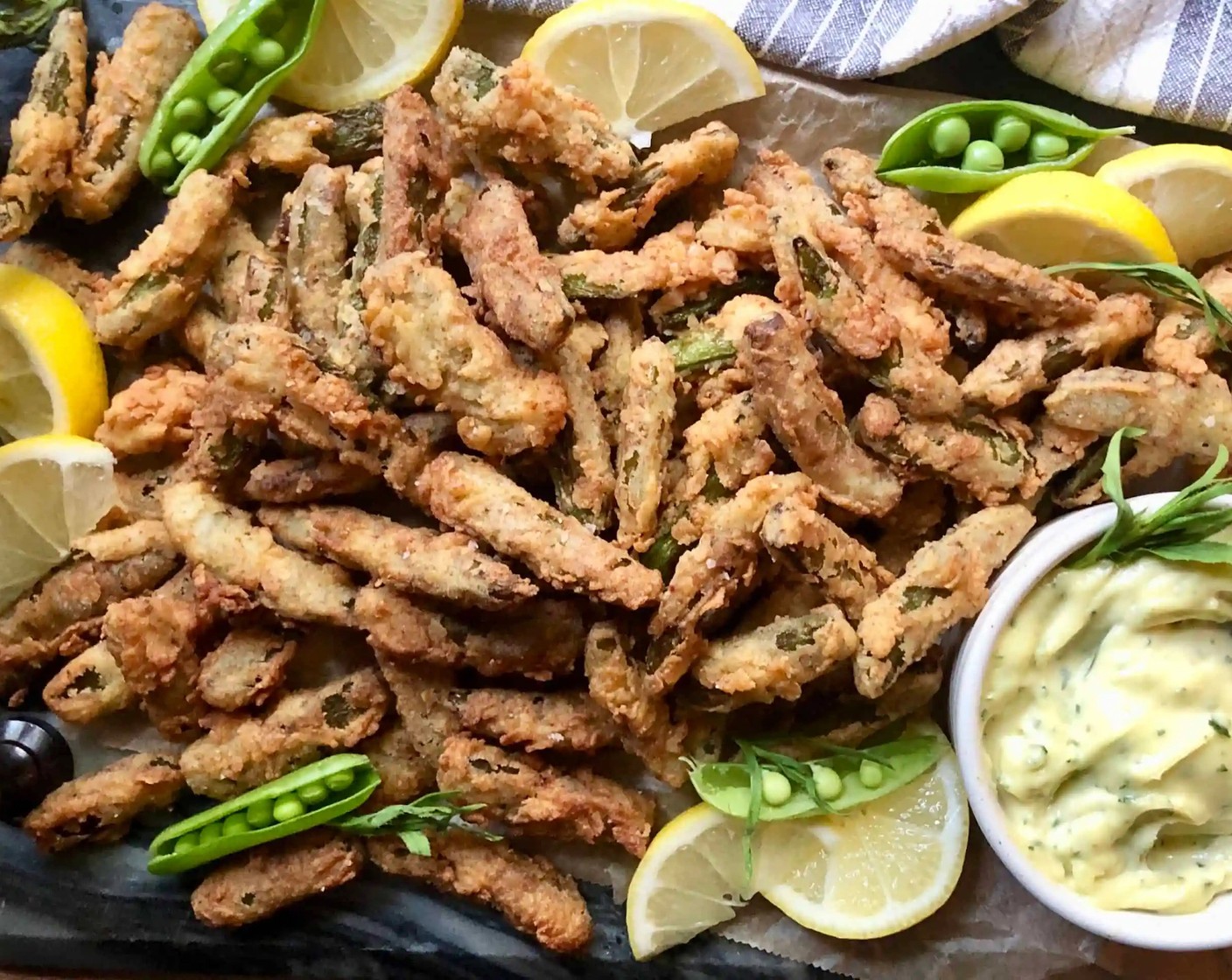 step 12 Repeat until all pea pods are fried, adjusting heat as needed to maintain oil temperature. Serve immediately with Lemon (1) and Tarragon Aïoli.