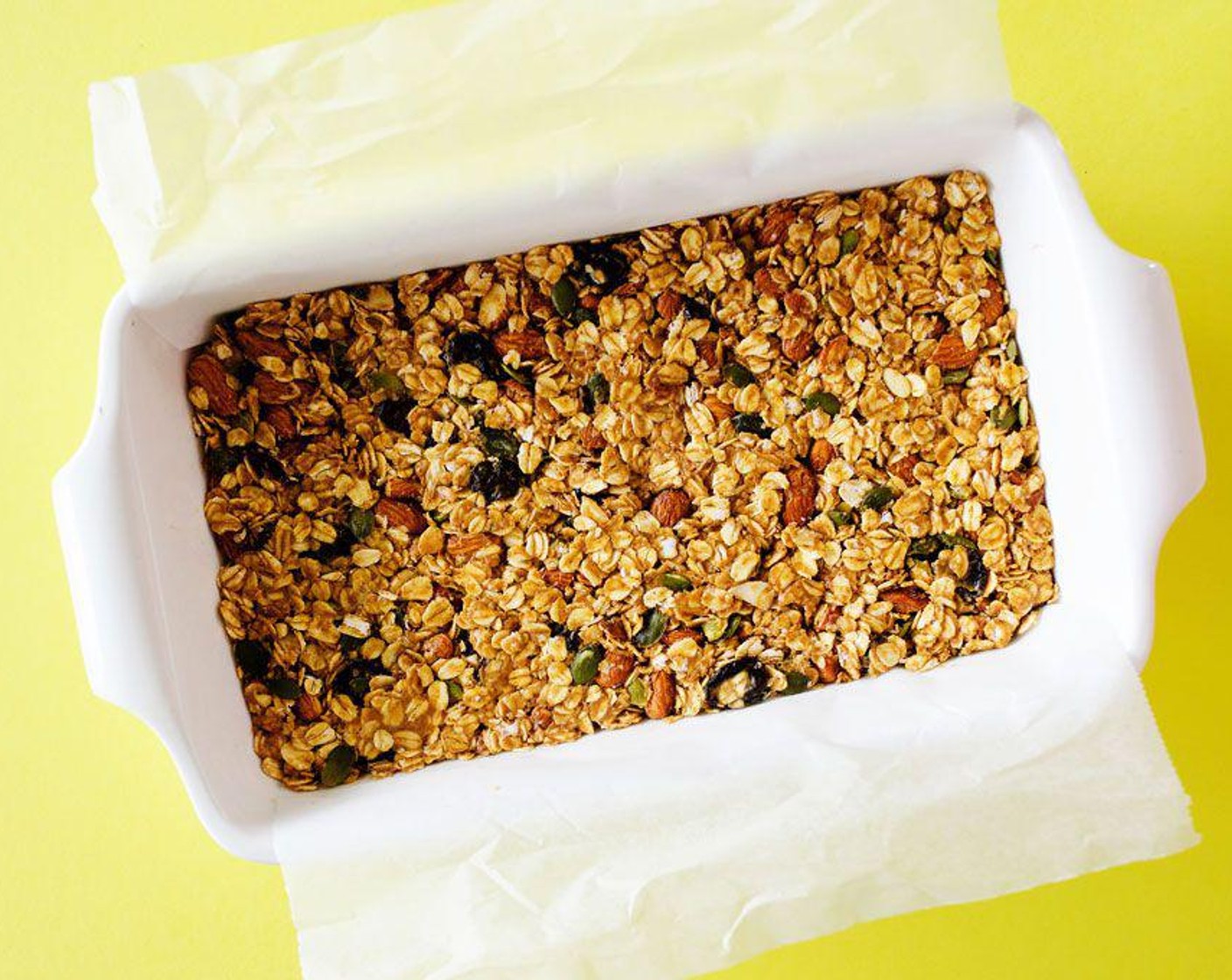 step 5 Pop granola in the freezer for 15 to 30 minutes to firm up, then cut into 9 to 12 bars.