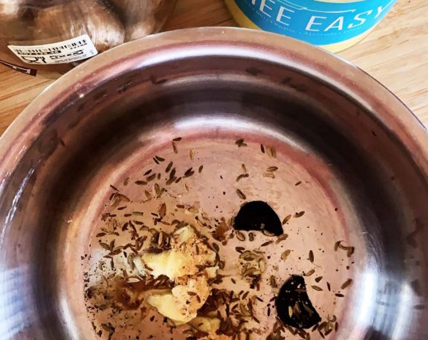 step 2 In a saucepan on medium heat, melt the Ghee (1 Tbsp). Then, add Fennel Seeds (1/4 tsp), Cumin Seeds (1/8 tsp), Ground Ginger (1/4 tsp), Ground Black Pepper (1/8 tsp), and Black Garlic (1/4 head) and toast for a few minutes.