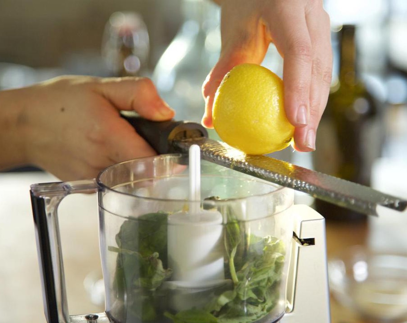 step 2 Zest 1/2 of the Lemon (1) directly into the food processor. Juice the lemon half into a small bowl and remove the seeds with a fork. Add the lemon juice to the food processor.