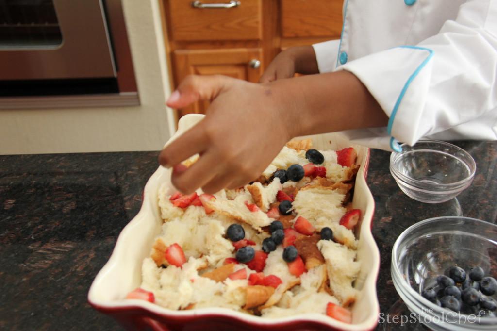 Step 3 of Berrylicious French Toast Casserole Recipe: Tear King's Hawaiian® Sweet Round Bread (1 package) into chunks and spread half of the bread evenly in the bottom of the dish. Add about half of the Fresh Blueberry (1/2 cup) and strawberries. Add remaining bread on top and then berries.