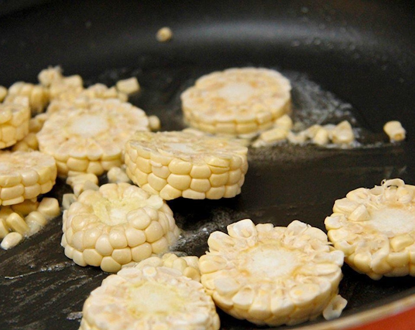 step 9 Heat a large pan and add 1 tablespoon of Unsalted Butter (1 Tbsp) along with 1 tablespoon of Olive Oil (1 Tbsp). Add the optional corn rounds first, and after a couple minutes, add the rest of the kernels.