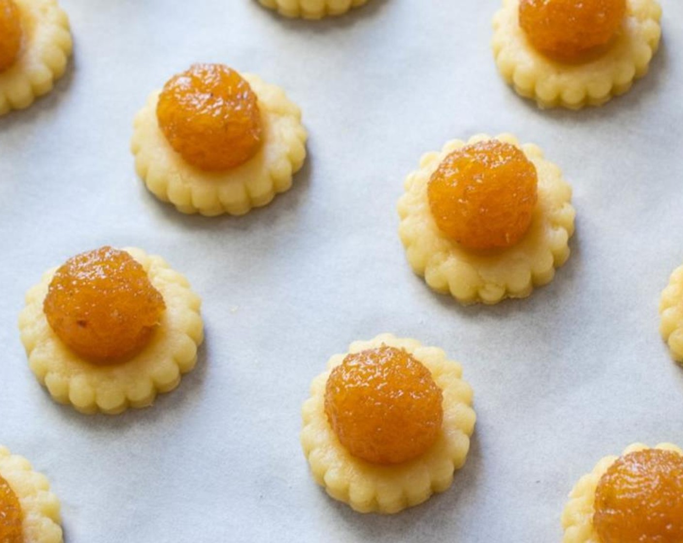 step 7 Use a rolling pin to roll out the pastry dough into a quarter inch thick sheet. Use a cookie cutter to cut out the dough. Make a divot in the center of the cookie, then place one ball of pineapple jam in the middle. Bake in the oven for 20-25 minutes.