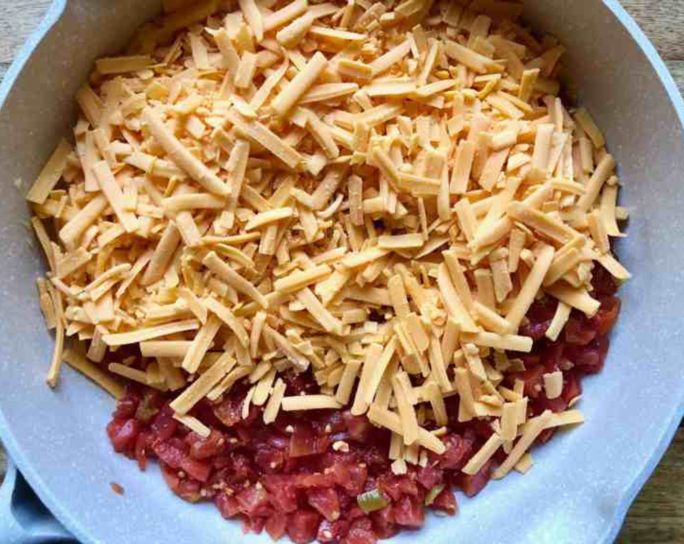 step 3 Add Shredded Cheddar Cheese (4 cups) and Diced Tomatoes with Green Chilies (1 can) to the pan. Cook over medium-low heat for 5 minutes or until the cheese thoroughly melts.