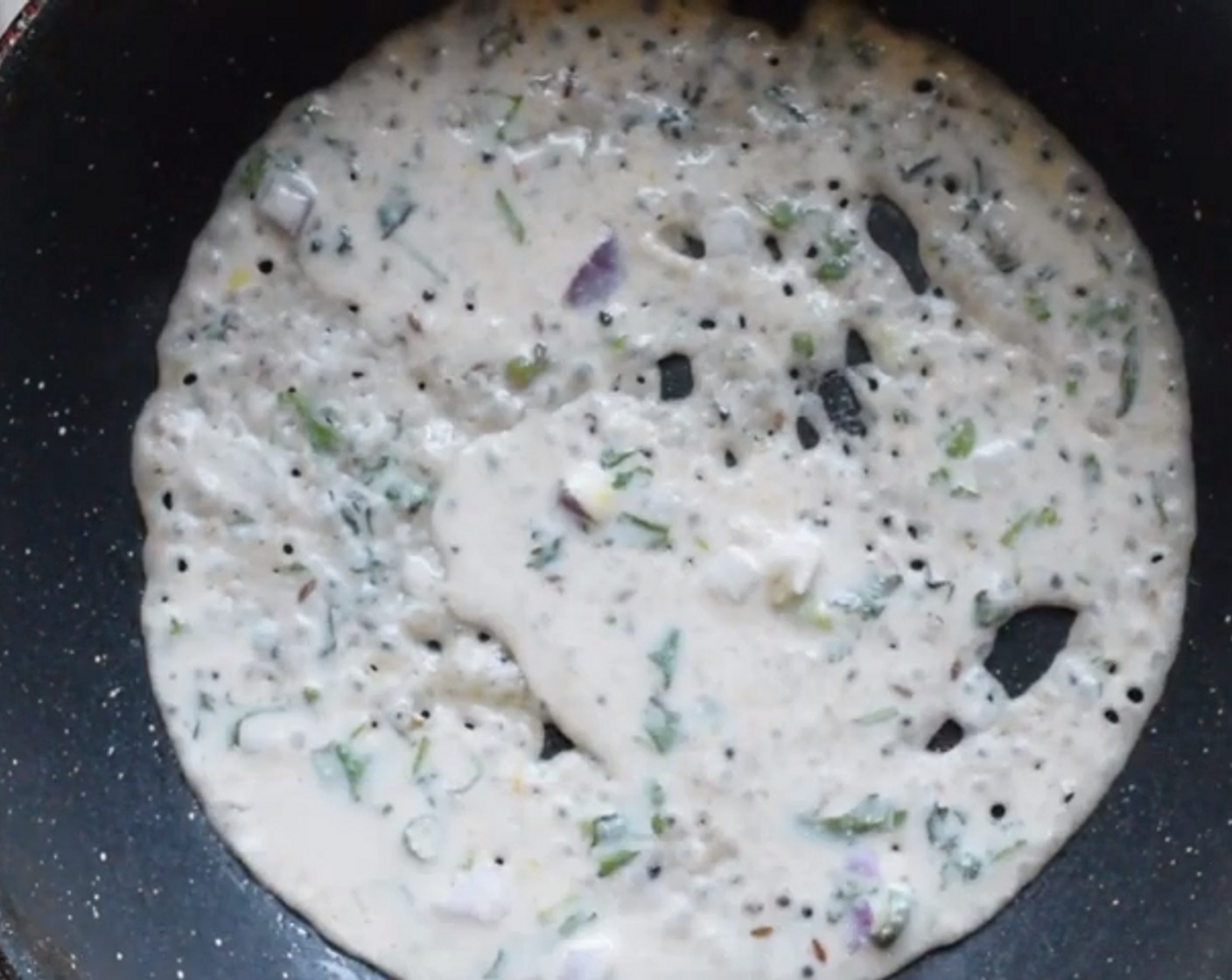 step 7 Begin to pour the batter from the outside to the inside. Do not try to spread it like a regular dosa or a pancake. The technique is similar to making a traditional rawa dosa.