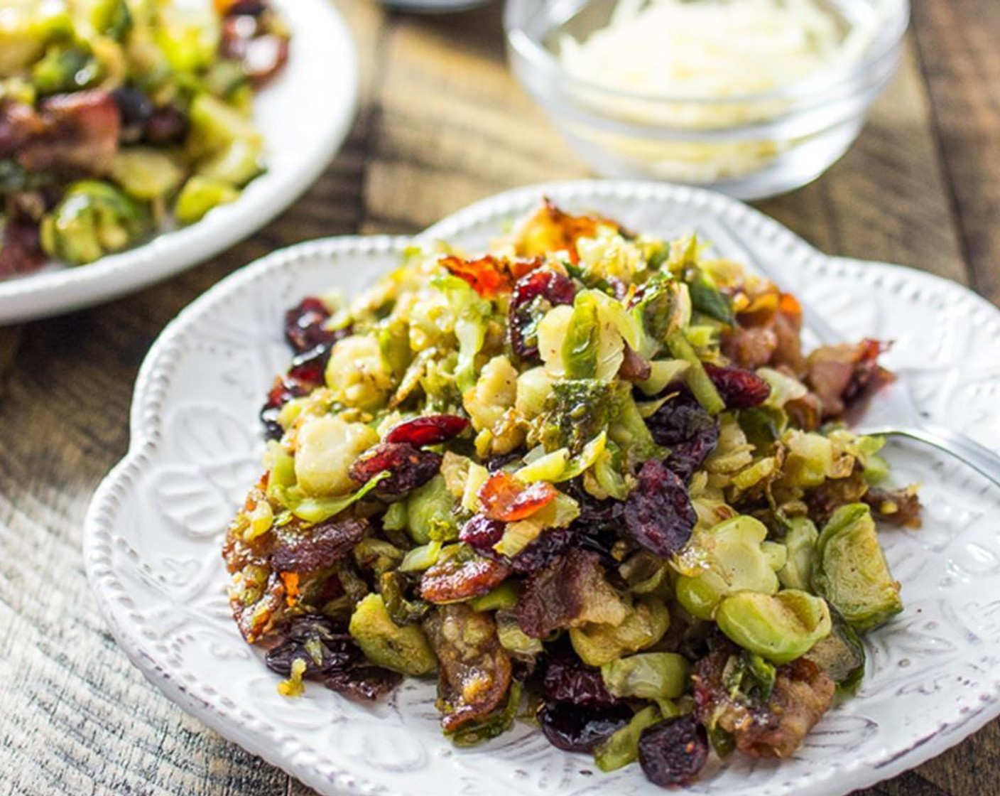 step 4 Add brussels sprouts to the pan and let them cook for 5 minutes, stirring occasionally. Add Dried Cranberries (1/3 cup), cook for 2 minutes, stirring regularly. Turn off the heat and transfer everything to a colander to drain. Serve with Shredded Parmesan Cheese (to taste). Enjoy!