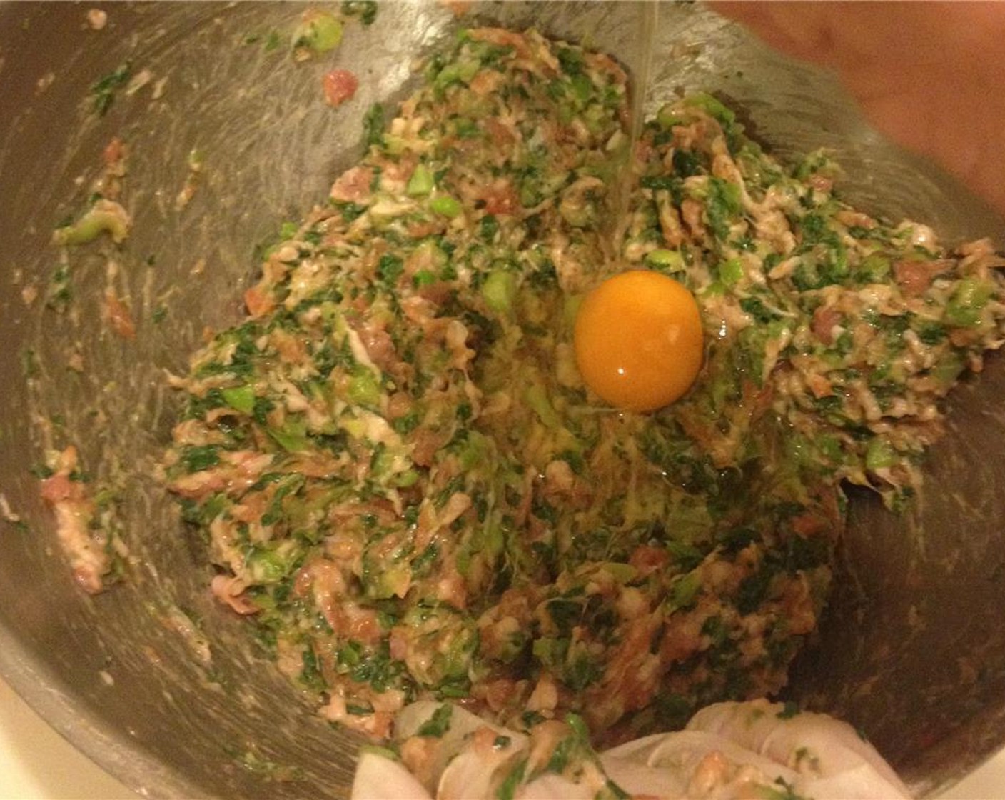 step 2 Combine Ground Pork (8 oz), Egg (1), chopped scallions, Soy Sauce (1 Tbsp), Ground Black Pepper (to taste) and Fresh Ginger (to taste).