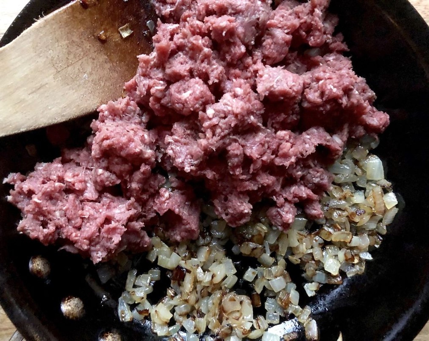 step 2 Add the Lean Ground Beef (1 lb), and break up and mix with the onion until browned. Mix in the Diced Tomatoes (1 can), Fresh Parsley (3 Tbsp), Paprika (1 tsp), Salt (1 tsp), and Finely Ground Black Pepper (1/2 tsp). Stir, cooking until the beef is cooked through. Remove from heat.