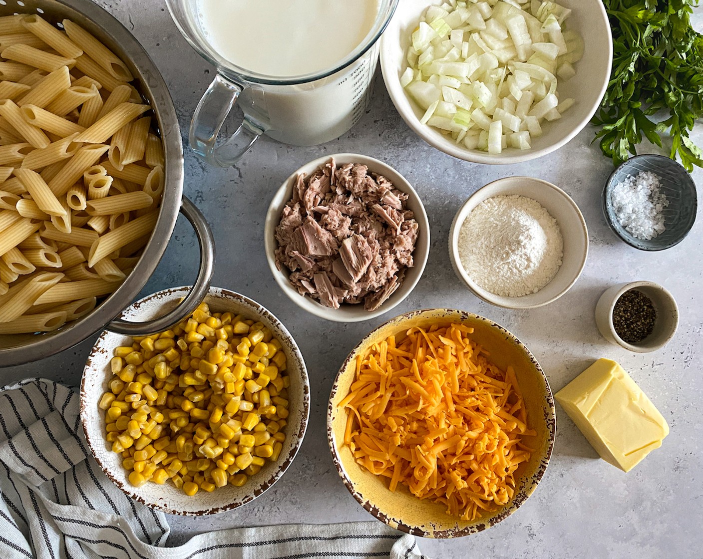 step 2 Grate the Cheddar Cheese (2 cups) and chop the Onion (1). When pasta is al dente (cooked but firm), drain and rinse with cold water. Set aside.